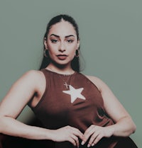 a woman sitting on a chair with a star on her chest